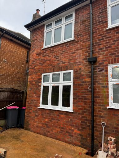 Completed garage conversion in Manchester with new window and matching bricks.