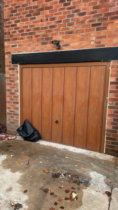 Garage before conversion in Manchester with original door.